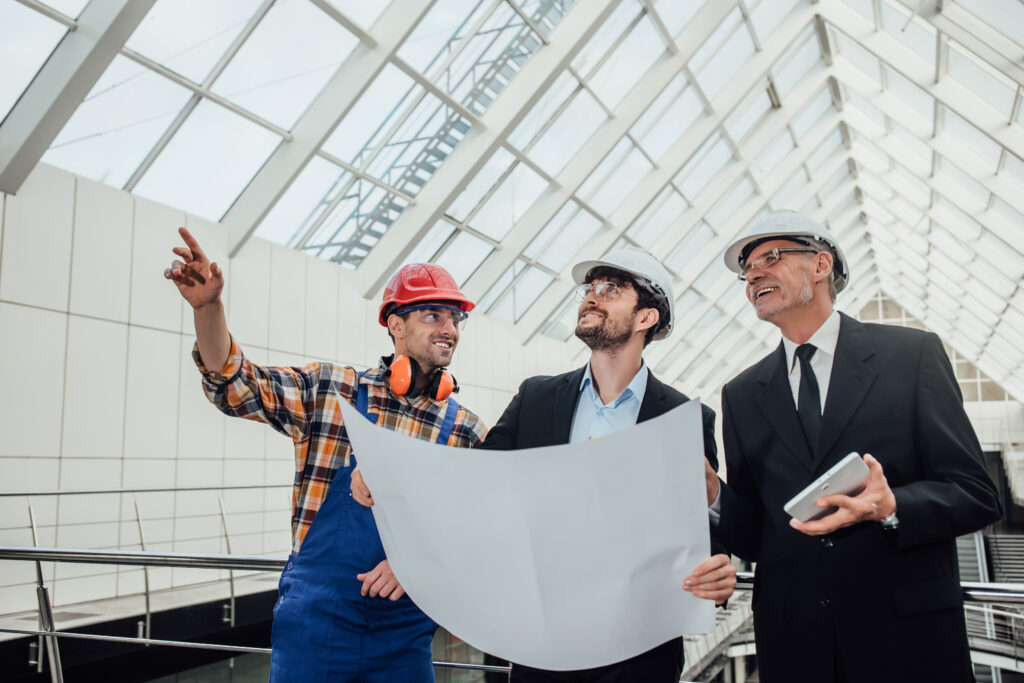 portrait of two successful architects and foreman discussing the